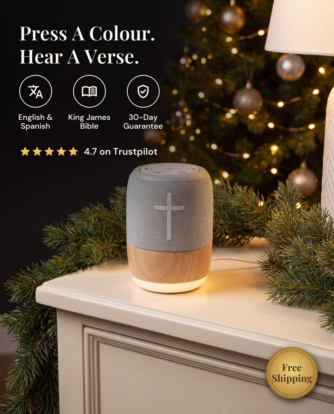 The verse player, grey fabric with a white cross on a light wood base, on a white dresser beside a Christmas tree.