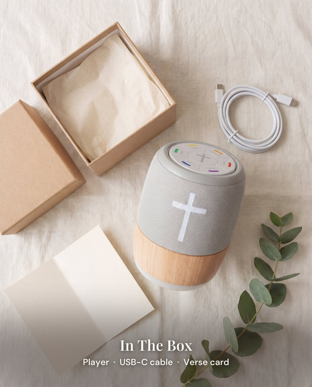 The player in its open kraft box with a coiled white USB-C cable and a blank card.